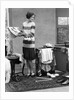 1920s woman packing clothes for travel by Anonymous