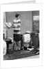 1920s woman packing clothes for travel by Anonymous