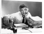 1950s portrait man overworked with desk full of papers by Anonymous