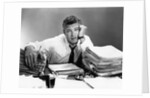 1950s portrait man overworked with desk full of papers by Anonymous