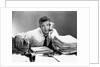 1950s portrait man overworked with desk full of papers by Anonymous