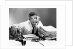 1950s portrait man overworked with desk full of papers by Anonymous