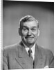 1950s mature middle aged man smiling business suit tie happy amused funny face expression by Anonymous