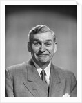 1950s mature middle aged man smiling business suit tie happy amused funny face expression by Anonymous