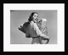 1950s smiling woman carrying grocery bags both hands looking at camera over her shoulder by Anonymous