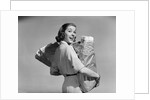 1950s smiling woman carrying grocery bags both hands looking at camera over her shoulder by Anonymous