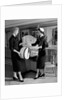 1950s woman in hat stole & gloves taking hatbox from saleswoman by Anonymous