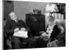 1930s elderly couple sitting in living room listening to radio woman knitting man with newspaper in lap by Anonymous