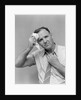 1940s 1950s perspiring man in rolled up shirt sleeves loosening tie holding handkerchief wiping forehead looking at camera by Anonymous