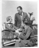 1930s two men one woman golf clubs bag smiling talking sitting bamboo chair man smoking pipe by Anonymous
