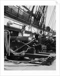 1930s row of cannon breeches on gun deck of sailing naval ship of war by Anonymous