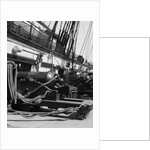 1930s row of cannon breeches on gun deck of sailing naval ship of war by Anonymous