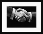 1930s close-up of businessmen's hands in handshake against dark background by Anonymous