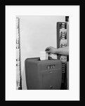 1950s man's hand punching time card by Anonymous