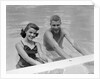 1950s teen couple in swimming pool smiling looking at camera by Anonymous
