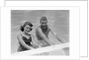 1950s teen couple in swimming pool smiling looking at camera by Anonymous