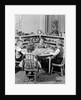 1950s 4 pre-school age children seated at small round table putting together jigsaw puzzle by Anonymous