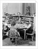 1950s 4 pre-school age children seated at small round table putting together jigsaw puzzle by Anonymous