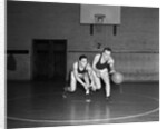 1930s two boys playing basketball inside court dribbling basketball by Anonymous