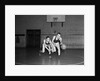 1930s two boys playing basketball inside court dribbling basketball by Anonymous