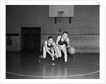 1930s two boys playing basketball inside court dribbling basketball by Anonymous