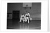 1930s two boys playing basketball inside court dribbling basketball by Anonymous