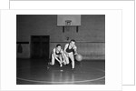 1930s two boys playing basketball inside court dribbling basketball by Anonymous