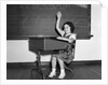 1930s 1940s smiling girl sitting at desk raising her hand by Anonymous