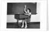 1930s 1940s smiling girl sitting at desk raising her hand by Anonymous