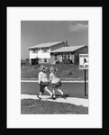 1950s back view of twin girls in plaid skirts & cardigans holding book bags running past school slow sign by Anonymous