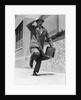 1960s 1950s frantic man running down street holding hat on with hand carrying briefcase wearing top coat by Anonymous