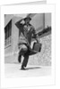1960s 1950s frantic man running down street holding hat on with hand carrying briefcase wearing top coat by Anonymous