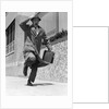 1960s 1950s frantic man running down street holding hat on with hand carrying briefcase wearing top coat by Anonymous