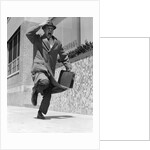 1960s 1950s frantic man running down street holding hat on with hand carrying briefcase wearing top coat by Anonymous