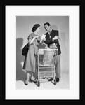 1950s couple man woman shopping cart reviewing grocery list man has cigar in hand by Anonymous