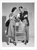1950s couple man woman shopping cart reviewing grocery list man has cigar in hand by Anonymous