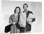 1950s couple smiling woman man carrying grocery bags smoking cigar looking at camera by Anonymous