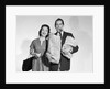 1950s couple smiling woman man carrying grocery bags smoking cigar looking at camera by Anonymous