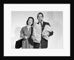 1950s couple smiling woman man carrying grocery bags smoking cigar looking at camera by Anonymous