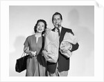 1950s couple smiling woman man carrying grocery bags smoking cigar looking at camera by Anonymous