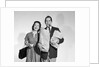 1950s couple smiling woman man carrying grocery bags smoking cigar looking at camera by Anonymous