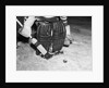 1940s 1950s close-up of padded goalie shown waist-down holding stick with puck in front of him by Anonymous