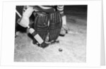1940s 1950s close-up of padded goalie shown waist-down holding stick with puck in front of him by Anonymous
