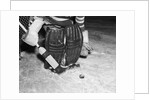 1940s 1950s close-up of padded goalie shown waist-down holding stick with puck in front of him by Anonymous
