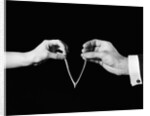 1940s man's & woman's hands pulling on either side of wishbone by Anonymous