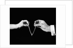 1940s man's & woman's hands pulling on either side of wishbone by Anonymous