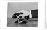 1930s 1940s man's hand on telephone by Anonymous