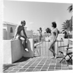 1930s man woman wearing bathing suits on terrace overlooking swimming pool woman on diving board by Anonymous
