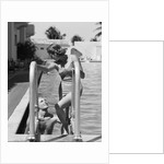 1930s woman wearing one piece bathing suit climbing out of swimming pool looking down at man smiling by Anonymous
