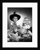 1950s boy & girl in pilgrim costumes with harvest arrangement on table by Anonymous